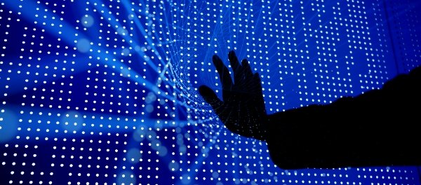 Hand pressed up against a blue screen with small dots and criss crossing lights 